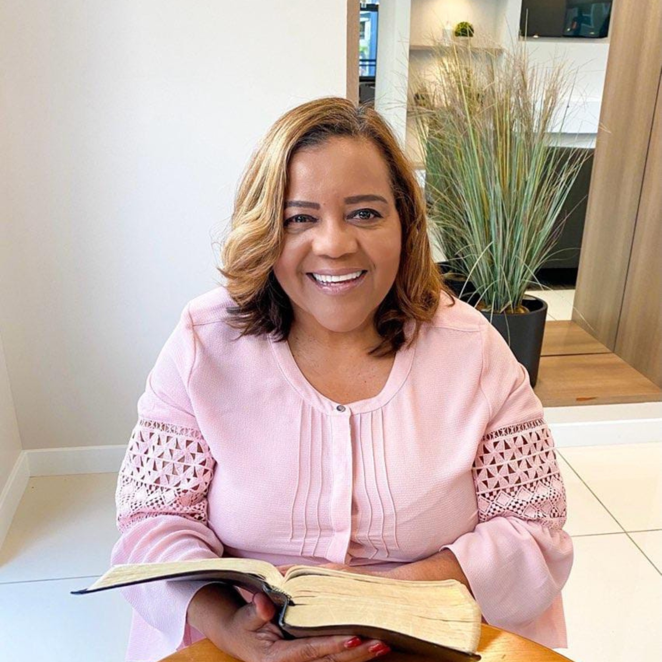 Rhonda Harris seated with an open Bible